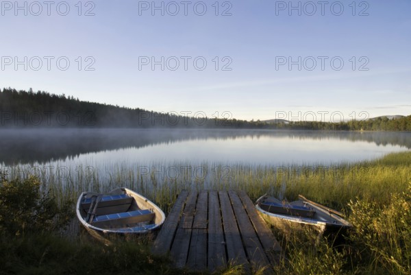 Moored boats in Lake Tevsjon near the Swedish village Ljusnedal early in the morning