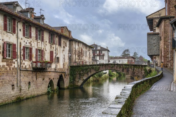Saint-Jean-Pied-de-Port, France, 17 April, 2024: view of the old town of Saint-Jean-Pied-de-Port with the stone bridge over the Nive River, Europe