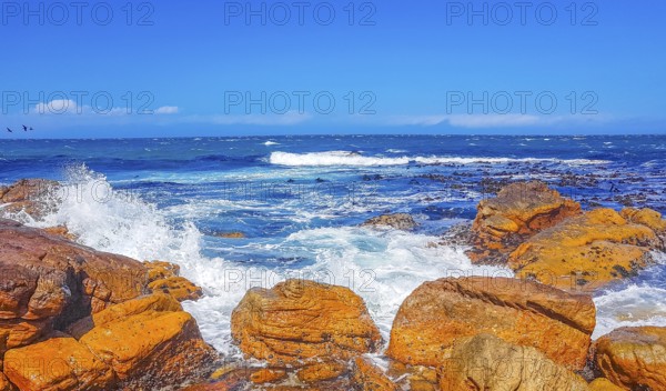False Bay rough coast landscape with boulders waves and mountains with clouds in Glencairn Simons Town Cape Town Western Cape South Africa