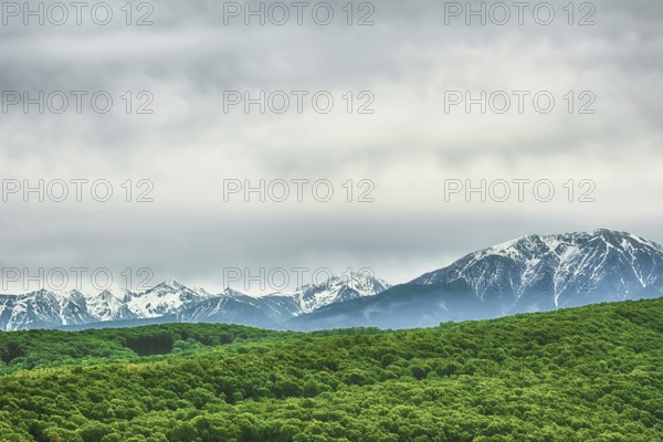Snow-covered Carpathian Mountains Behind the Hills Romania