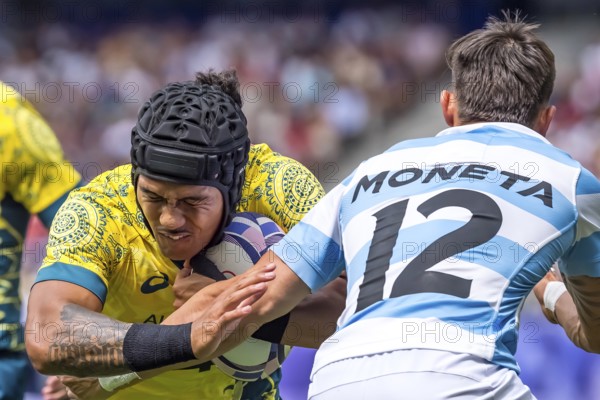 Men?s Pool B Rugby Seven: Team Australia back Dietrich Roache (4) (AUS) fights for the ball during the match between Team Australia (AUS) against Team Argentina (ARG) at the Paris 2024 Olympic Games at Stade de France in Saint-Denis, France. Australia wins the match 14-22