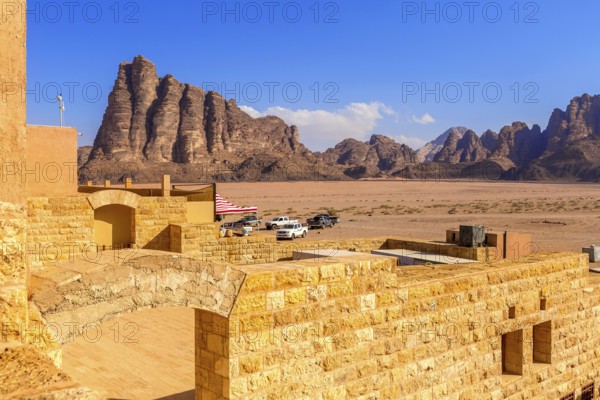 Jordan, Wadi Rum, November 2, 2022: Cars near the entrance to Wadi Rum desert with Seven Pillars of Wisdom rock formation, Asia