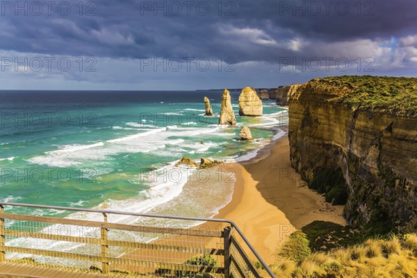 Observation deck on the Pacific coast near Melbourne. The well-known rocks Twelve Apostles in an ocean storm surf. The concept of active and phototourism