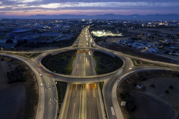 Aerial drone top view of a modern motorway junction roundabout with cars moving fast. Transportation infrastructure, Nicosia Cyprus