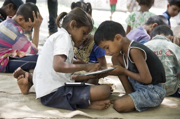 Children studying on tablet, varanasi, uttar pradesh, india, asia