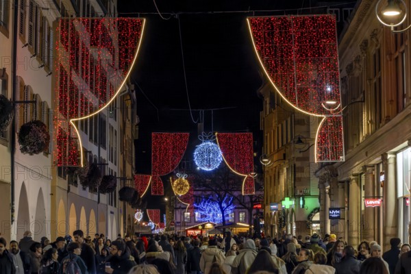 Night street, red curtain, decorated for Christmas with a crowd of people, Strasbourg, Alsace, France, Europe