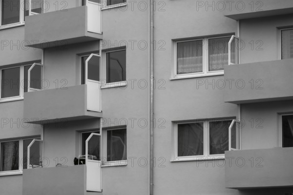 Modern residential building facade with balconies and windows, showcasing urban living and architectural design