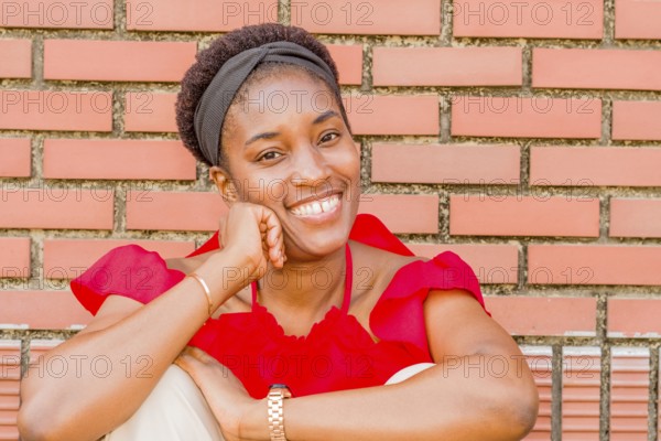 Woman sitting in front of a brick wall, smiling warmly with a headband and watch, Taken in Daejeon, South Korea, Asia