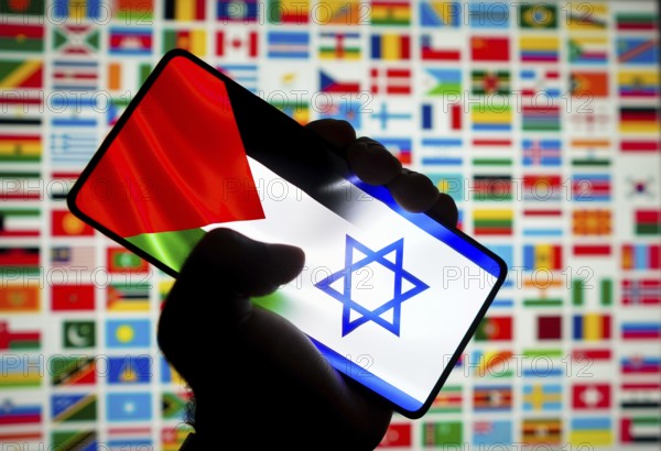 In this photo illustration, the flag of Israel and Palestine is displayed on a smartphone screen and in the background the flags of several countries