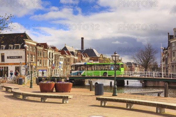 Leiden, Netherlands, April 7, 2016: Street view with traditional houses, bridge and people in Leiden, Holland