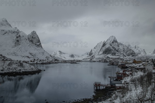 Red rorbu, winter, snowfall, Reine fjord, Lofoten, Nordland norway