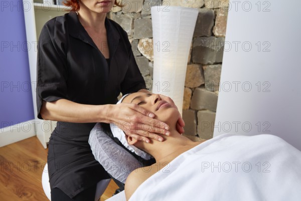 Head neck and facial massage woman with physiotherapist indoor
