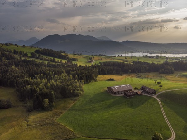 A farm in the Swiss Alps photographed from the air at sunset