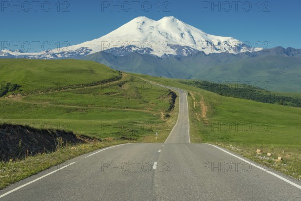 Road leading to mount Elbrus with green meadows at summer. North Caucasus, Russia, Europe