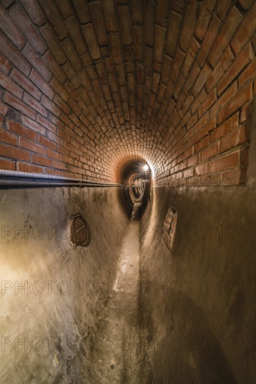 Anderlecht, Brussels, Belgium, 07 16 2019- Industrial interiors of the sewer museum showing an rebuild old fashioned brick stone tunnel, Europe