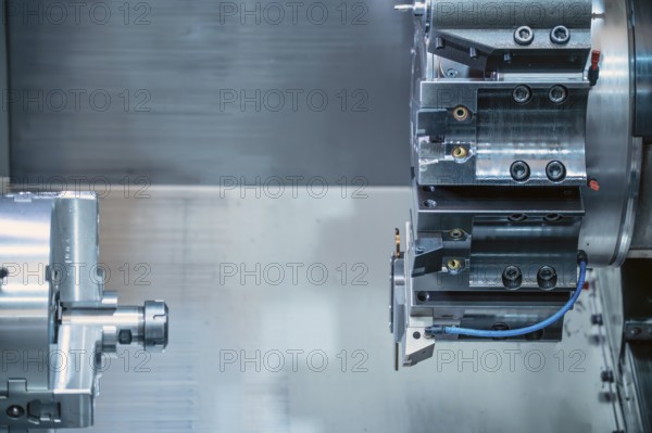 The CNC lathe machine forming cutting the metal parts. hi-technology metal working by CNC turning machine, graphy