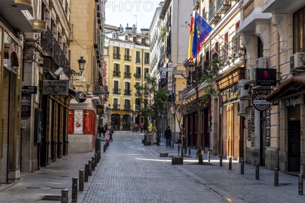 Madrid, Spain, April, 18 2021: Victoria Street Near Puerta del Sol Square. Empty view during coronavirus pandemic. The Street is Famous for the Taverns, bars, inns and pubs, Europe