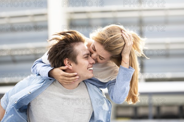 Happy to spending time together. Young beautiful couple outdoor fashion portrait. Attractive boy and girl hugging and kissing