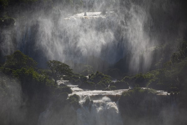 Mystical view to waterfall cascades with a wall of spray and sunlight, Iguazu Falls, Misiones, Argentina, South America
