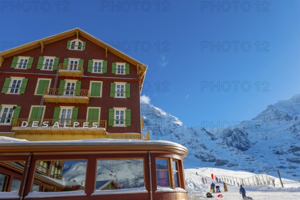 The Famous and Historical Hotel Bellevue des Alpes at 2061 Meters High Up and Mountain Peak of Mönch and Jungfrau and a Ski Slope in a Sunny Winter Day in Kleine Scheidegg, Grindelwald, Canton Bern, Switzerland, Europe