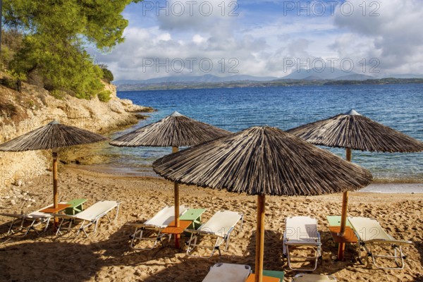 Greek island Spetses, beach with awnings, Idyllic place for recreation, not so noisy as Mykonos. Fresh air, transparent water, beautiful beaches