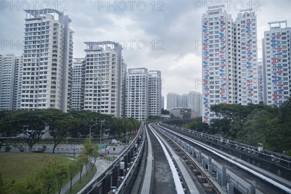 30.07.2023, Singapore, Republic of Singapore, Asia, View from a fully automated shuttle train of the Sengkang LRT Line onto typical HDB (Housing and Development Board) residential high-rise buildings of public housing in the Sengkang district, Asia