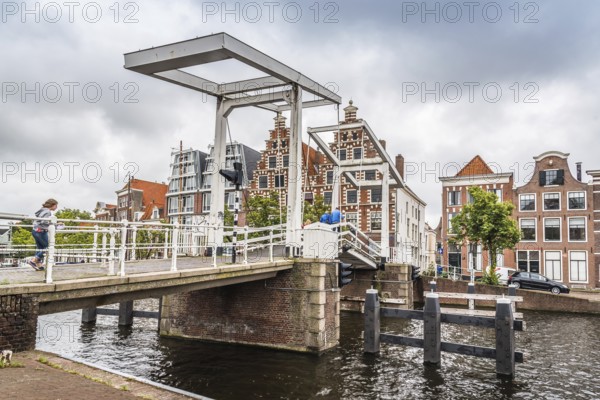 Haarlem, Netherlands, August 3, 2016: Picturesque landscape with beautiful traditional houses and bridge in canal of Haarlem