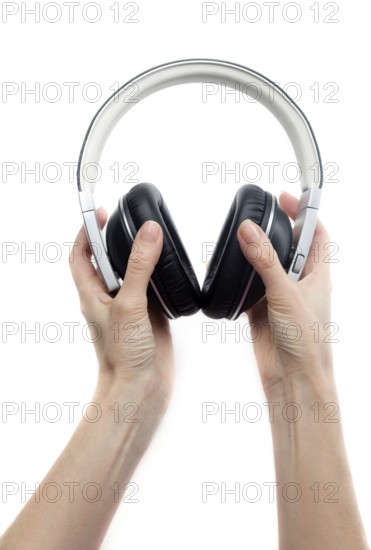 Leather earphones in female hands. Isolate on white