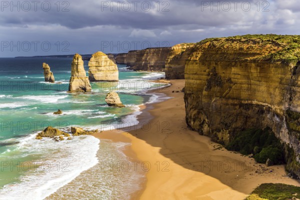 Travel to Australia. Magic morning light on the Pacific coast near Melbourne. Famous rocks Twelve Apostles in ocean waves surf. The concept of active and phototourism