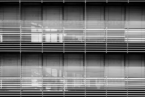 The modern façade of a chemical building and laboratory with highly light-reflecting metal blinds for solar shading