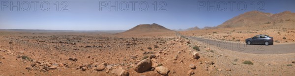 Panoramic desert landscape in the Souss-Massa region, a car driving on a road, Morocco, Africa
