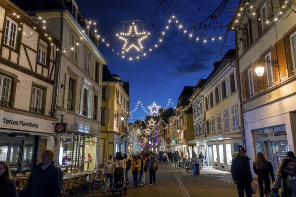 A street decorated for Christmas in the evening lighting atmosphere, Colmar, Alsace, Département Bas-Rhin, France, Europe