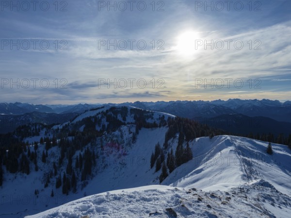 View from Seekarkarkreuz, a mountain in the Bavarian alps, Germany, along its ridge towards the sun, Europe