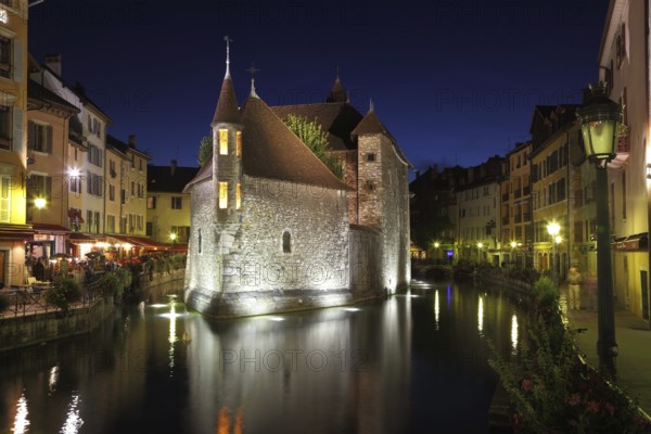 The capital of the Haute-Savoie - Annecy. The main attraction of the city - an ancient fortress-prison on an island in the middle of the river. Fortress beautifully lit and is reflected in the smooth water