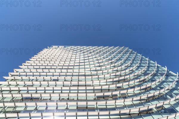 Madrid, Spain, May 1, 2019: Low angle view of Modern skyscraper in AZCA Financial District against blue sky, Europe