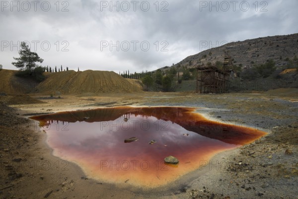 Lake with red polluted toxic water of an Abandoned copper mine at Mitsero area in Cyprus
