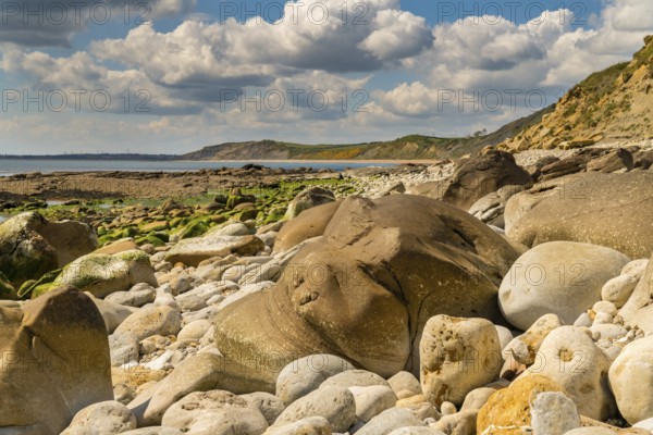 Stones and clouds at Osmington Bay, Osmington Mills, near Weymouth, Jurassic Coast, Dorset, UK