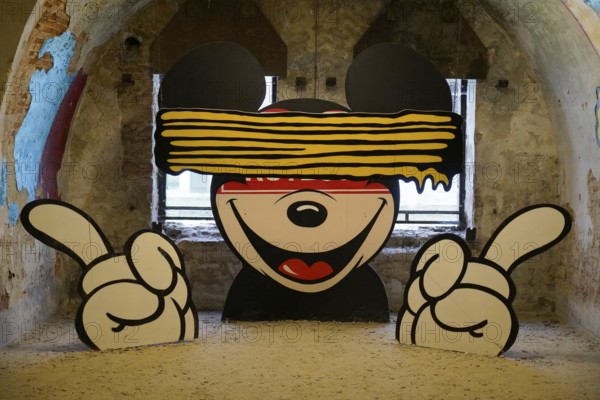 MAUSA VAUBAN, Museum of Urban Art and Street Art, Neuf-Brisach Fortress, France, Europe, A stylised mural of Mickey Mouse with an eye slit, highlighted by bold colours, Europe