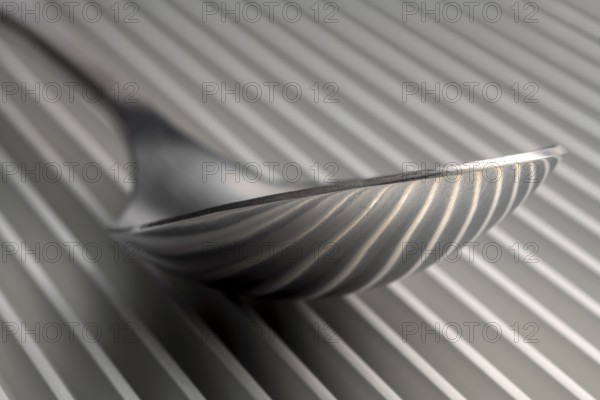 Abstract artistic picture of a spoon on a parallel grid structure