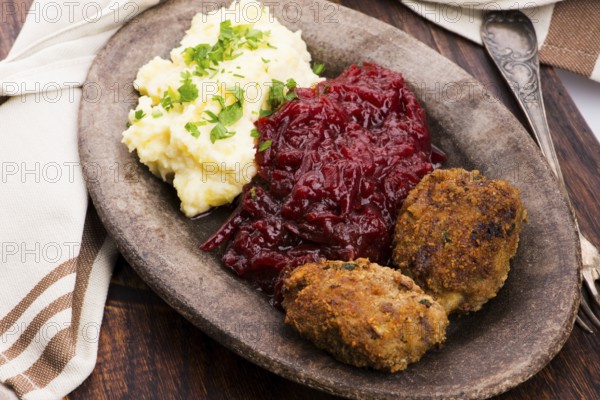 Prepared dinner on the plate. Melted meat, potatoes, beetroot