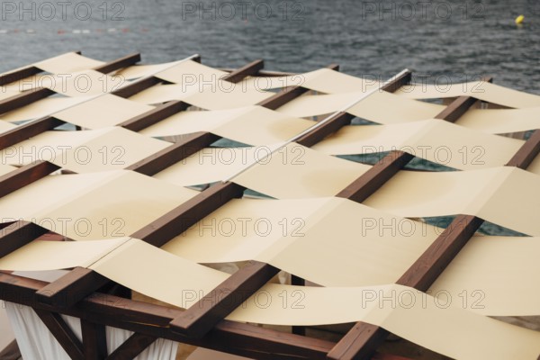 Unusual roof closure. The roof of the restaurant on the street by the sea. The fabric roof. SUMMER TERRASSA
