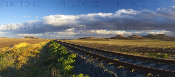 Single railway track at sunset, Central Bohemian Uplands, Czech Republic. Railway track in nature park Central Bohemian Highlands, Czech Republic. Panorama image
