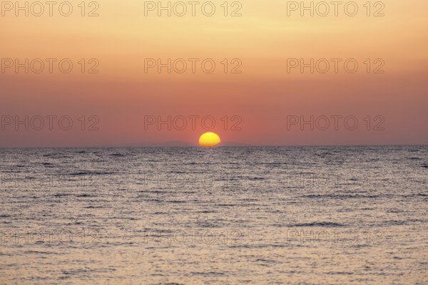 Sunrise over the sea, view from Kamari, island of Santorini, Cyclades, Greece, Europe