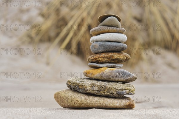 Stone pyramid on the beach at Zingst. Stones stacked on top of each other by the sea