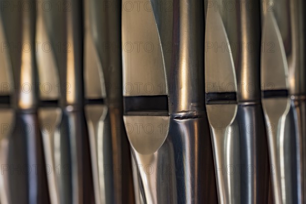 Close-up of lead organ pipes standing in a row in a church