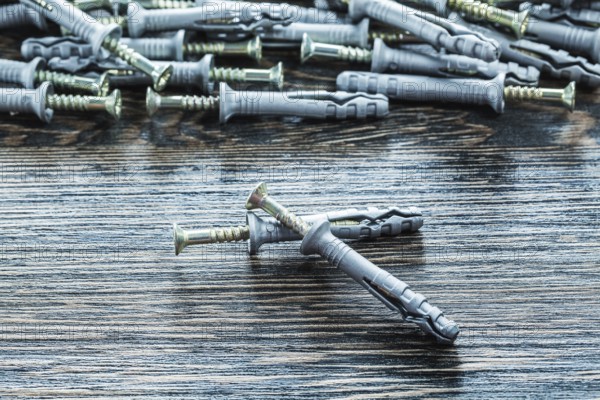Heap of plastic dowel nails on wooden board