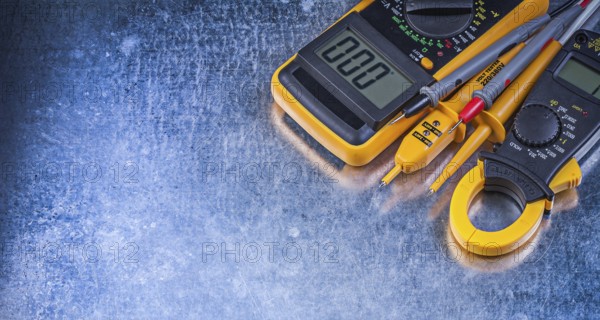 Digital ammeter electric tester multimeter on metallic background