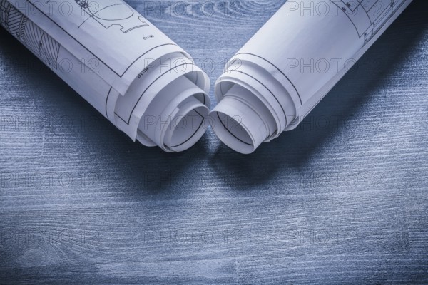View on two white rolls of blueprints