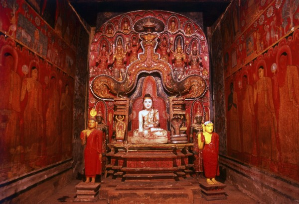 The Medawala Rajamaha Viharaya or Tempitiya Vihara, north of Kandy is a typical <i>tempath vihara</i>, a small wooden image house or shrine, placed on stilts or piles. The <i>tempath vihara</i> can be regarded as Kandy's most significant contribution to Buddhist architecture, but there are not many specimen of its kind left.<br/><br/> Some of the frescoes in the Rajamaha Viharaya depict the king and the royal family, but they also depict the everyday life of the commoners, such as a farmer tilling his field with the help of a white bull. One enigmatic painting shows a recumbent Buddha, sleeping safely tucked away behind a mosquito net.<br/><br/> Though the frescoes exhibit all the hallmarks of the 18th century, the original construction of the Raja Mahavihara is said to go back to much earlier times. Despite the artistic merit of the frescoes, the most remarkable single feature in the image house is the small ivory figure of a Buddha. The figure is surrounded by an intricately carved w...