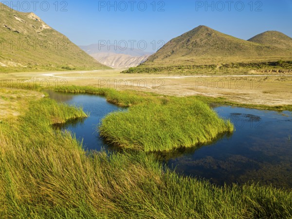 Landscape in Oman, mountains, Wadi Ashawq, road, reeds, waters Salalah, Al Mughsyal / Wadi Ashawq, Dhofar, Oman, Asia